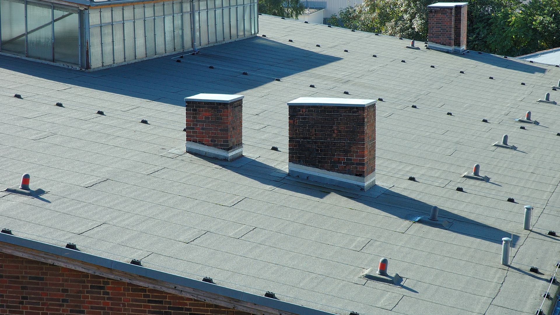 A couple of chimneys sitting on top of a roof